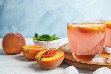 Photo of Tasty peach cocktail on table. Refreshing drink