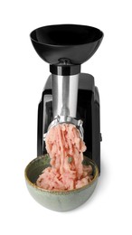 Photo of Electric meat grinder with chicken mince and bowl isolated on white