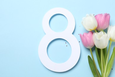 8th of March greeting card design with paper number eight, beautiful flowers and space for text on light blue background, flat lay. International Women's day