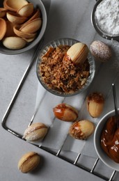 Delicious walnut shaped cookies with condensed milk on grey table, flat lay