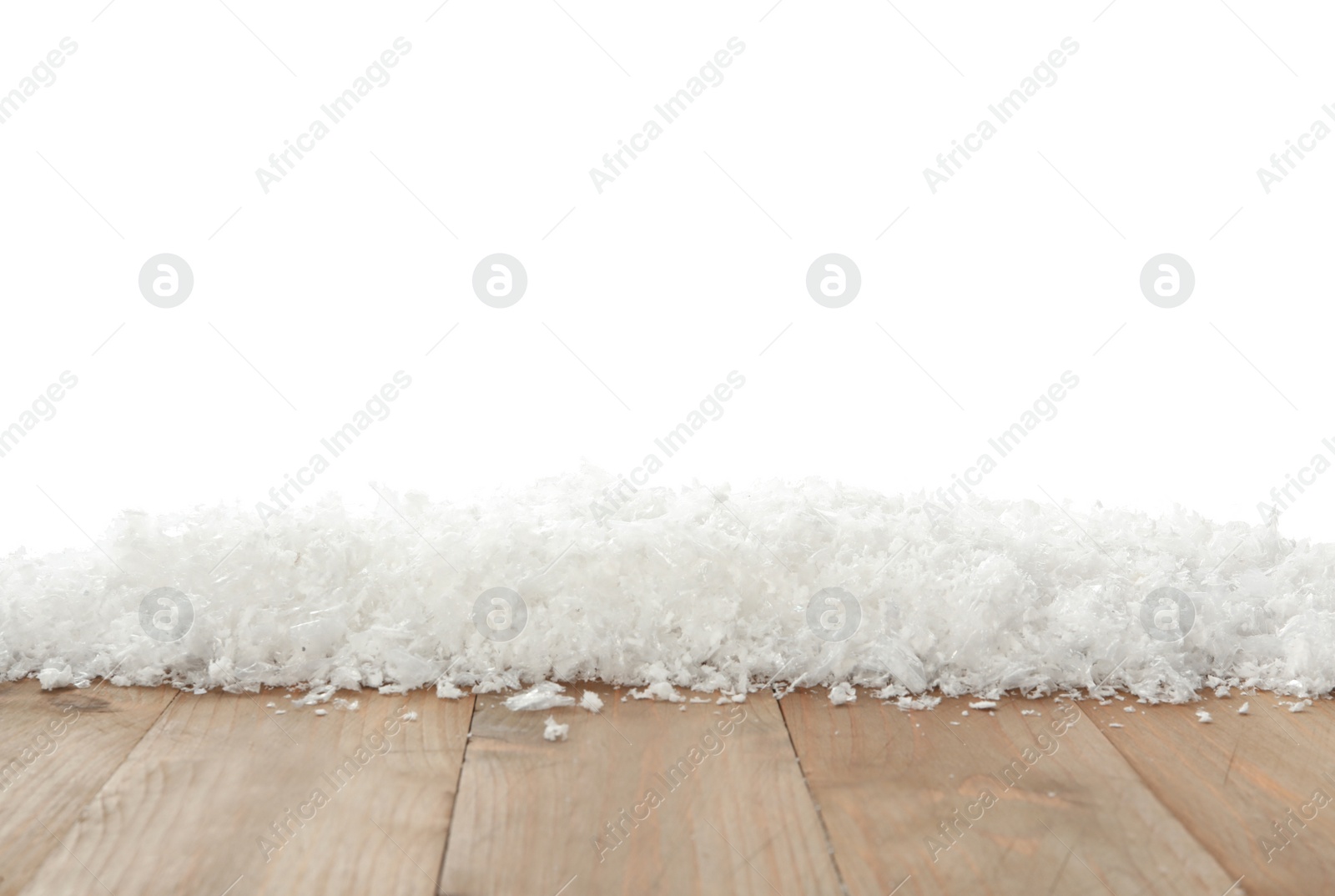 Photo of Snow on wooden surface against white background. Christmas season