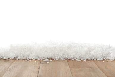 Snow on wooden surface against white background. Christmas season