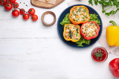 Photo of Flat lay composition with tasty stuffed bell peppers on white wooden table, space for text