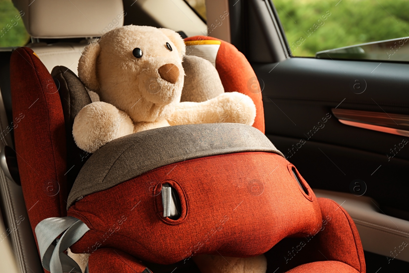 Photo of Safety seat for baby with cute toy bear