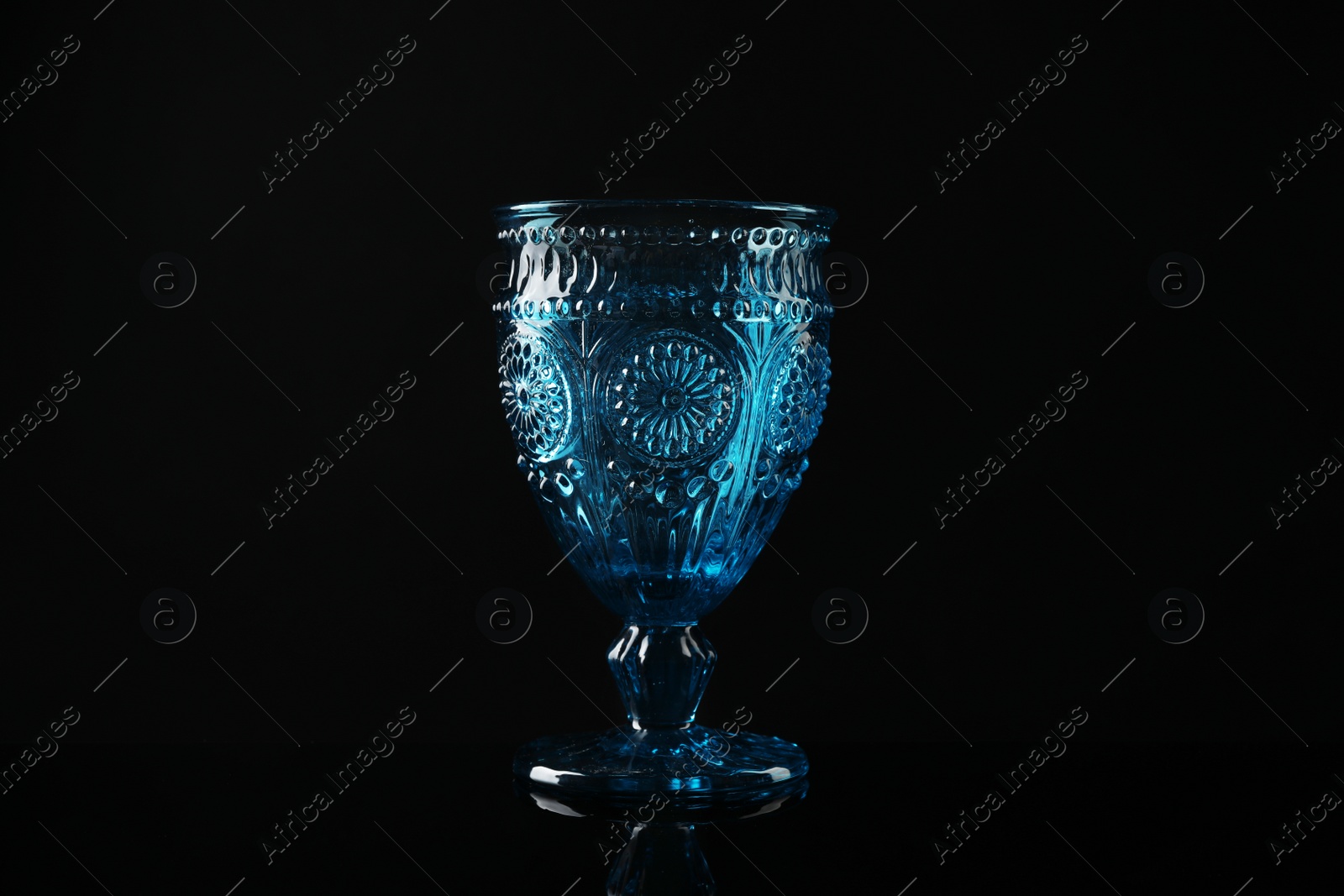 Photo of Elegant empty colorful glass on black background