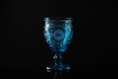 Elegant empty colorful glass on black background