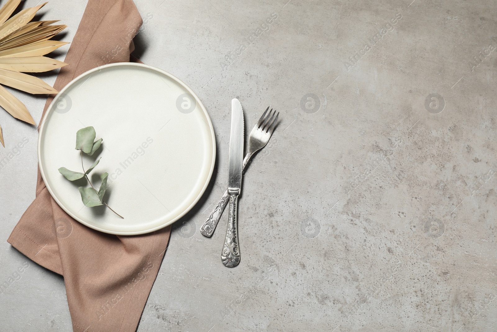 Photo of Setting with beautiful cutlery on textured table, top view. Space for text