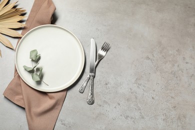 Photo of Setting with beautiful cutlery on textured table, top view. Space for text