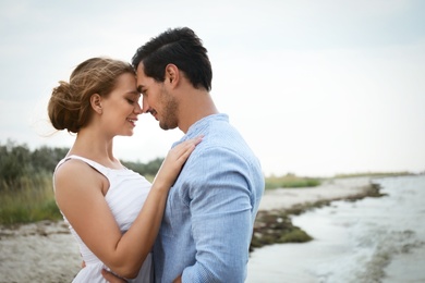 Happy young couple spending time at sea beach