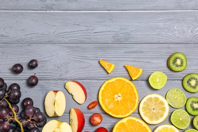 Photo of Rainbow composition with fresh fruits on wooden background, flat lay