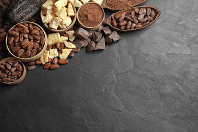 Flat lay composition with organic cocoa butter on black table. Space for text