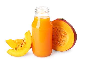 Glass bottle with pumpkin juice and fresh vegetable on white background