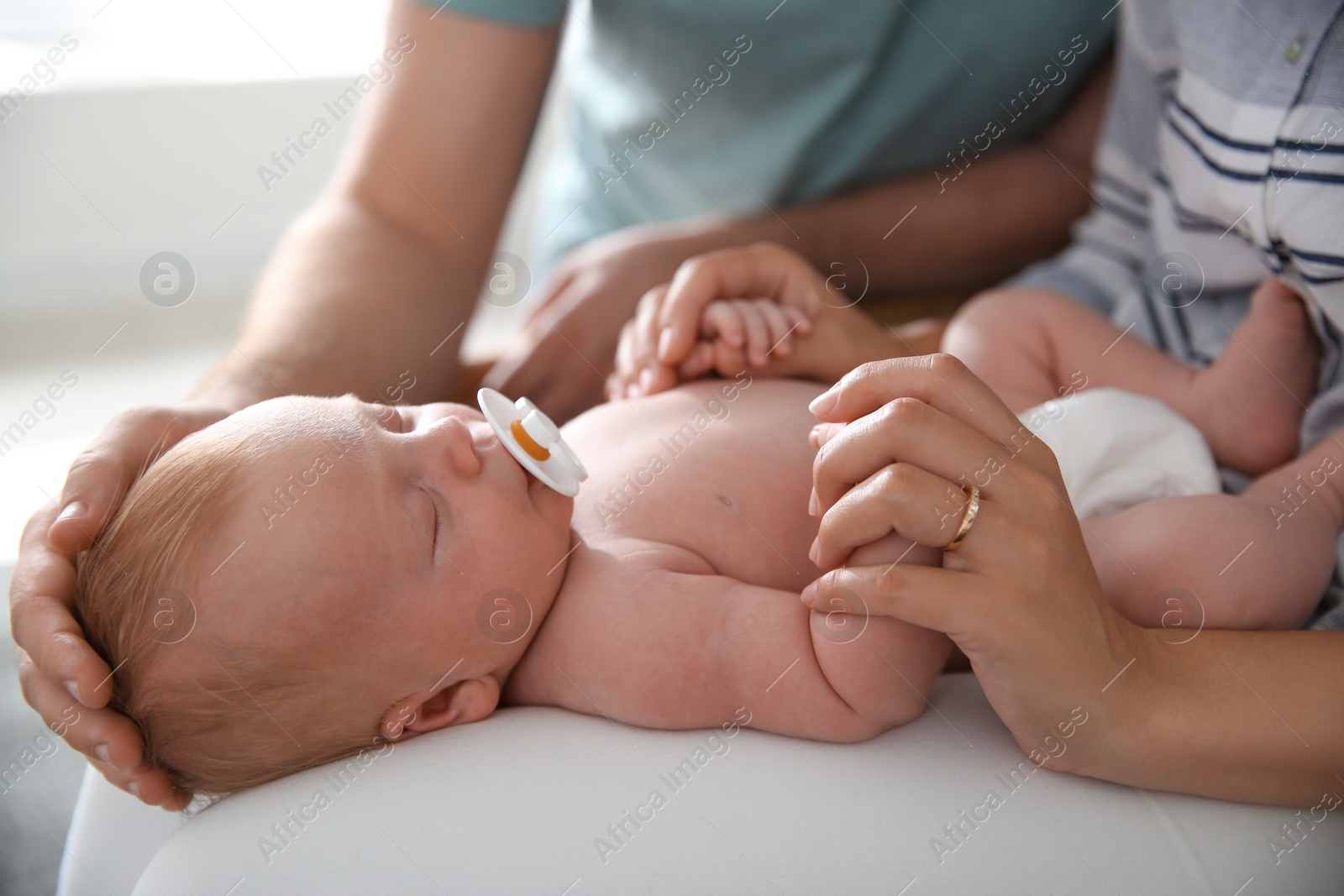 Photo of Couple with their newborn baby, closeup view