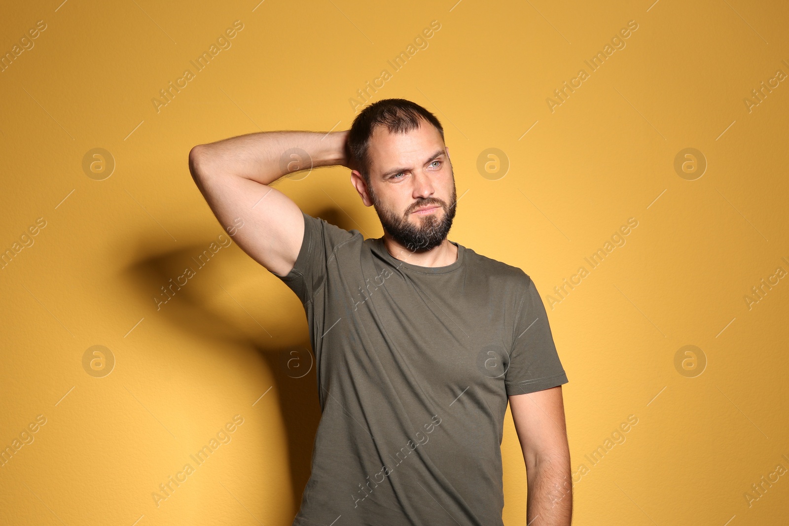 Photo of Portrait of man in casual clothes on color background