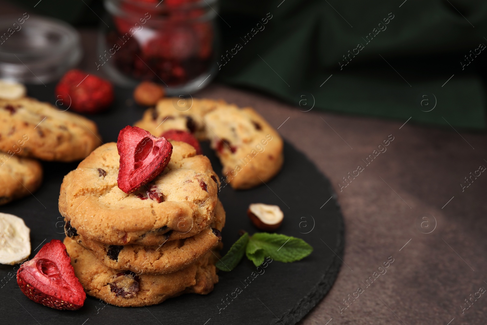 Cookies with freeze dried fruits, mint and nuts on grey table, closeup. Space for text Photo of Cookies with freeze dried fruits, mint and nuts on grey table, closeup. Space for text