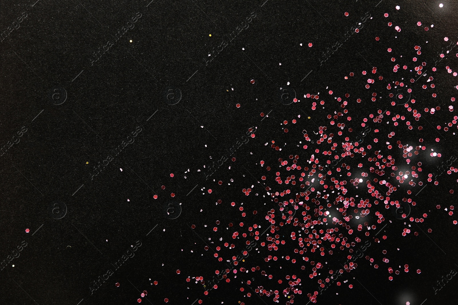 Photo of Rose gold glitter on black background, top view with space for text