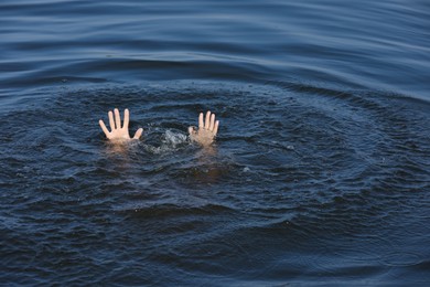 Drowning man reaching for help in sea, closeup