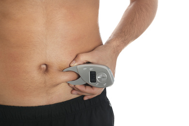 Photo of Man measuring body fat layer with digital caliper on white background, closeup. Nutritionist's tool