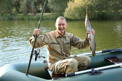 Man with rod and catch fishing from boat. Recreational activity