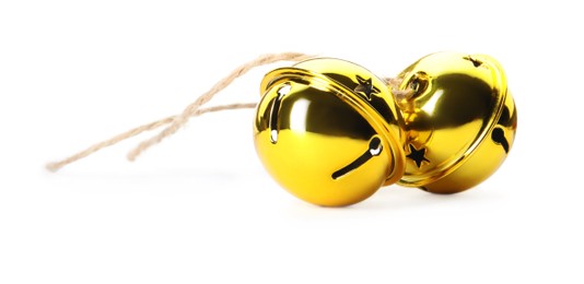 Photo of Shiny golden sleigh bells on white background