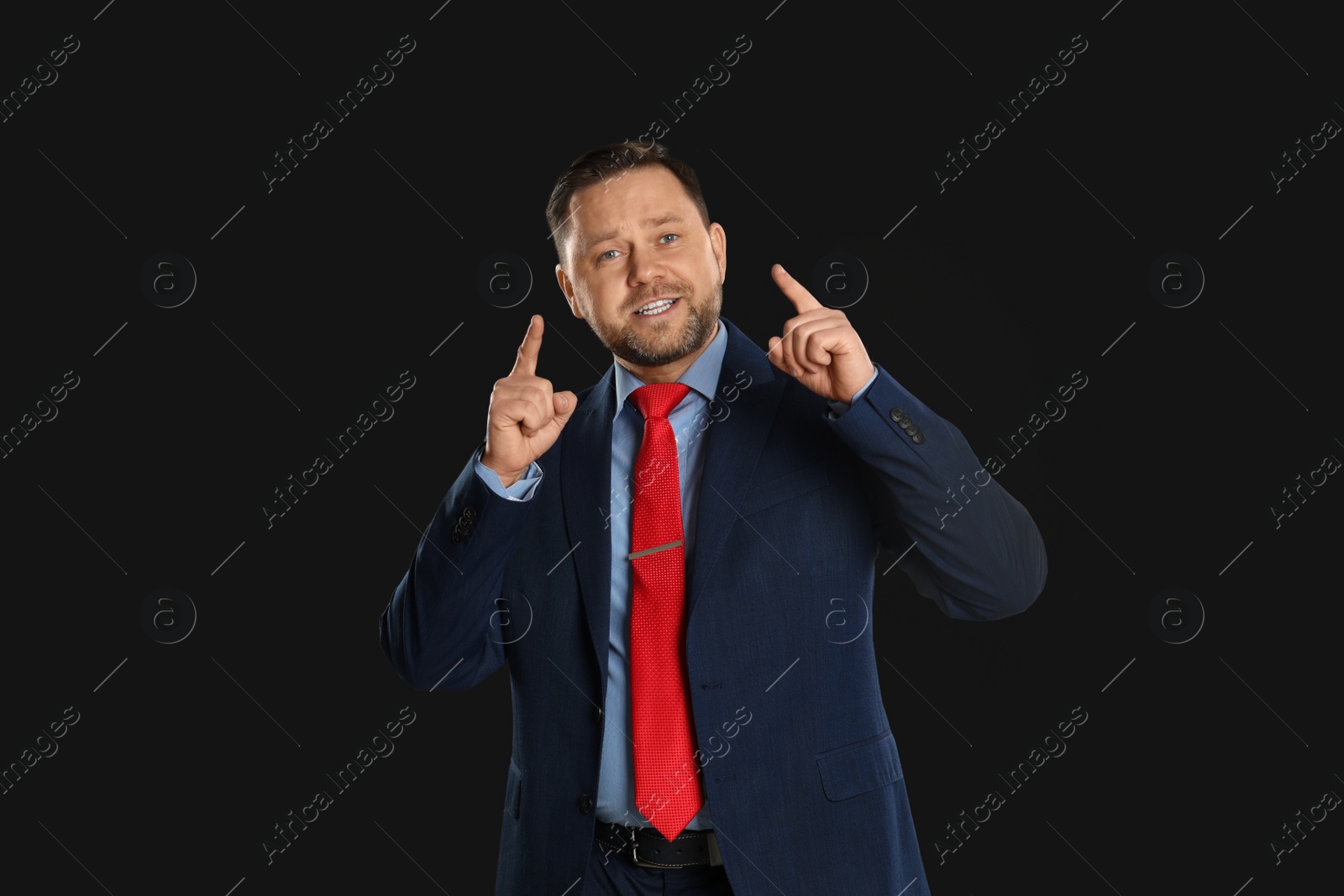 Photo of Portrait of happy mature man on black background