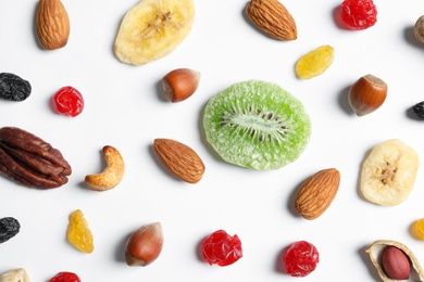 Flat lay composition of different dried fruits and nuts on white background