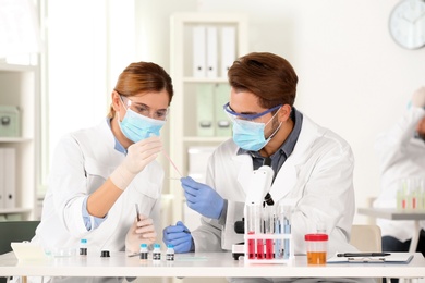 Scientists working at table in laboratory. Research and analysis