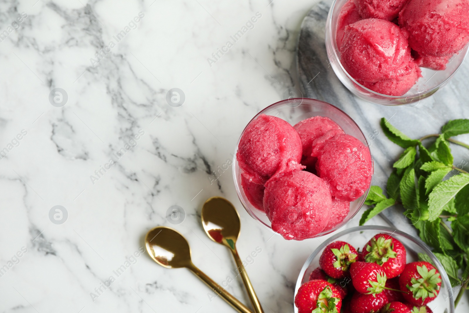 Photo of Flat lay composition with pink ice cream, mint and strawberries on marble table. Space for text