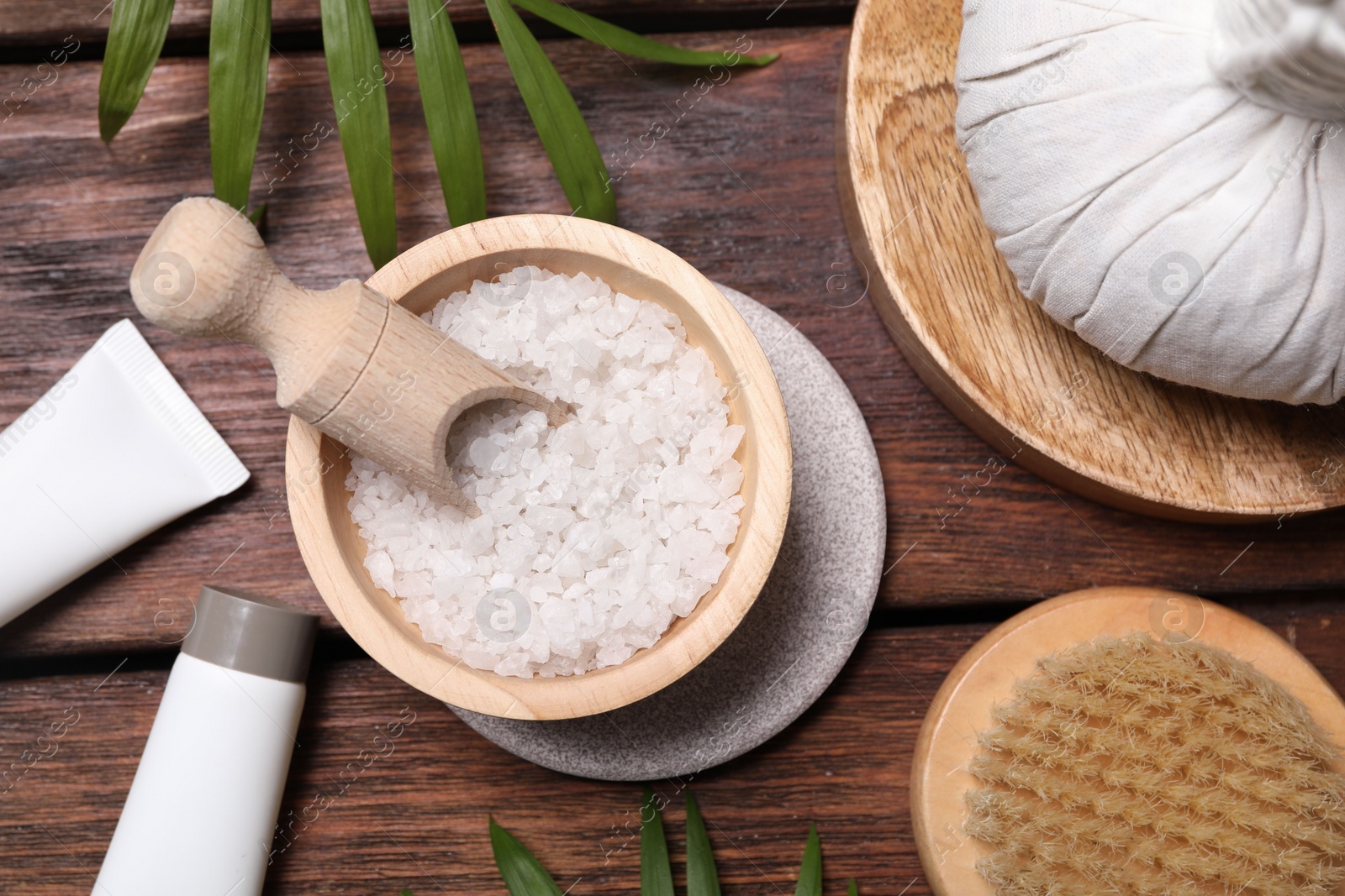 Photo of Flat lay composition with spa products and green leaves on wooden table