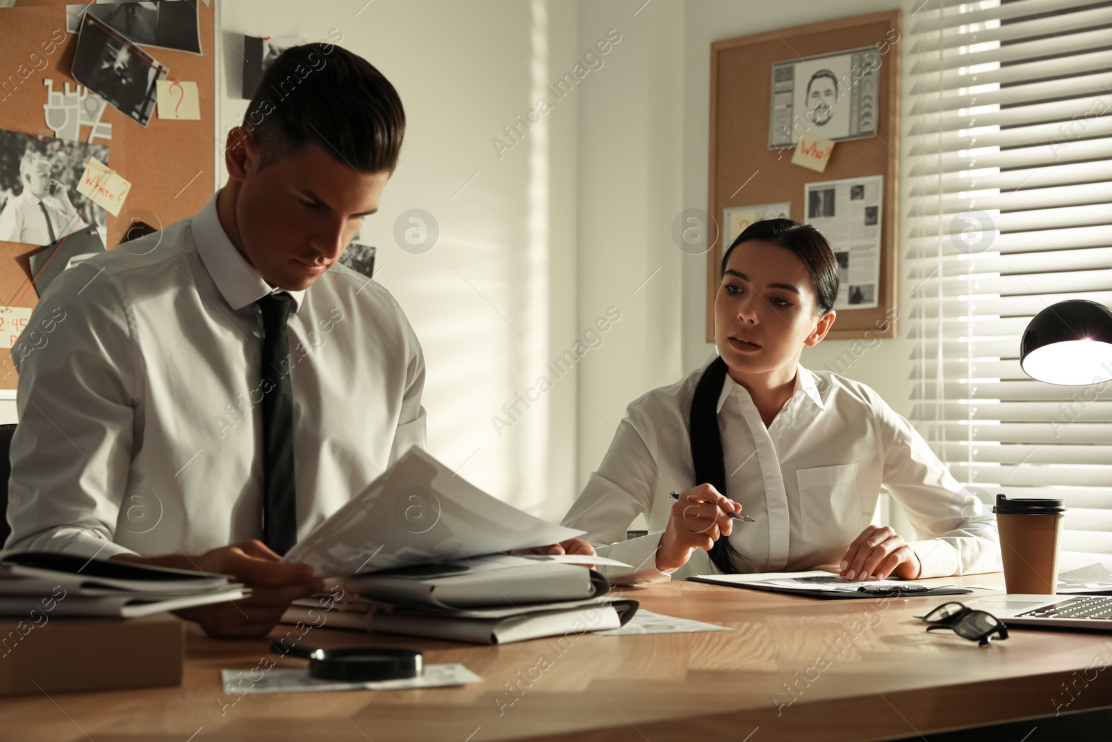 Photo of Professional detectives working at desk in office