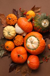 Photo of Flat lay composition with different ripe pumpkins on brown background