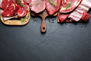 Photo of Flat lay composition with fresh meat on grey table. Space for text
