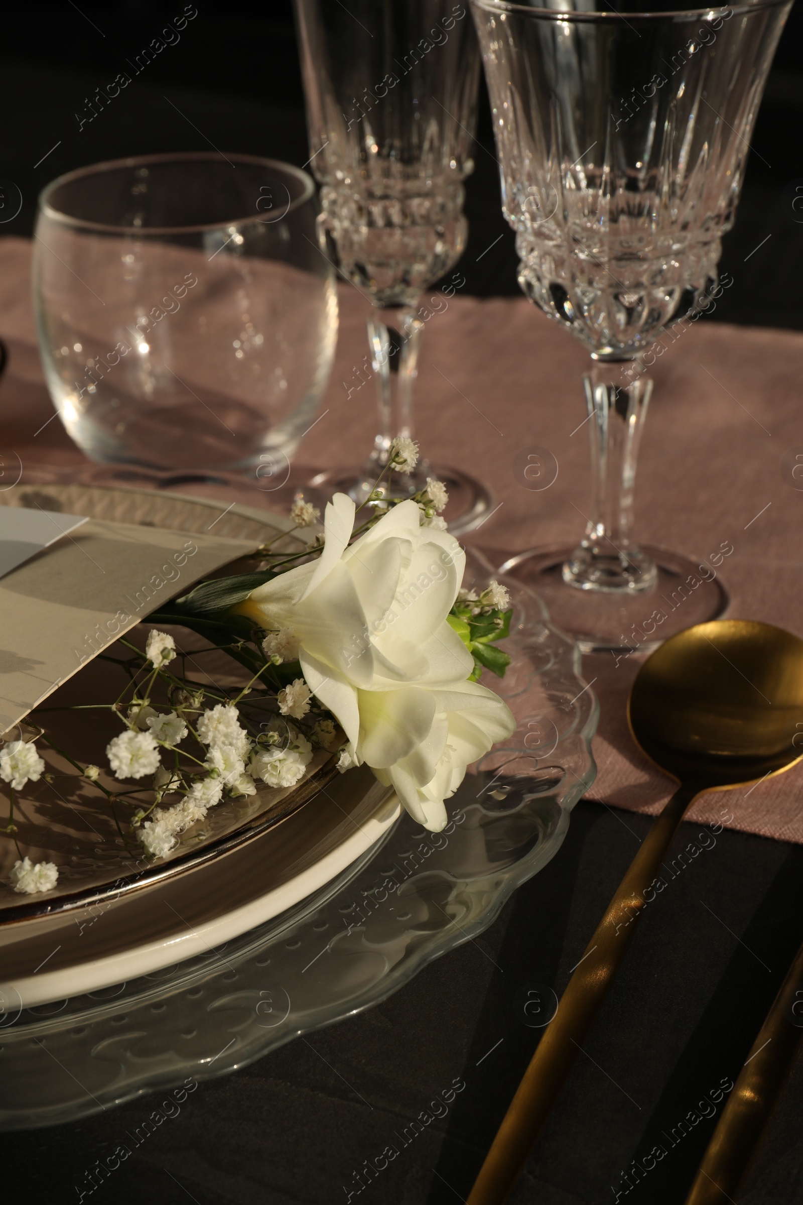 Photo of Stylish table setting. Plates, cutlery, glasses and floral decor