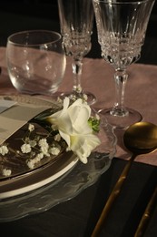 Photo of Stylish table setting. Plates, cutlery, glasses and floral decor