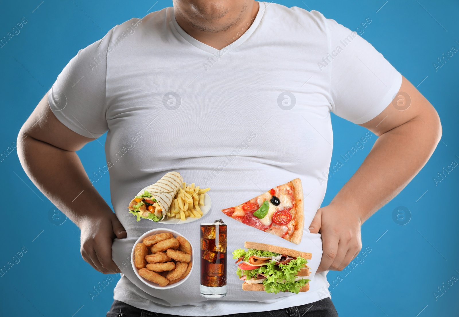 Image of Overweight man in tight t-shirt with images of different unhealthy food on his belly against light blue background