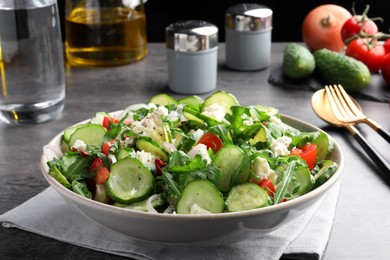 Photo of Plate of delicious cucumber salad served on grey table