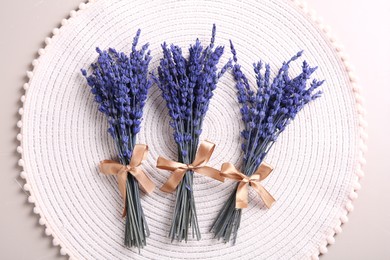 Photo of Bouquets of beautiful preserved lavender flowers on light grey table, top view