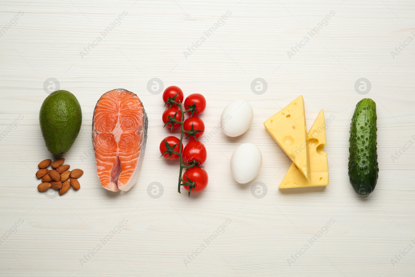 Photo of Flat lay composition with fresh organic products on white wooden table. Keto diet