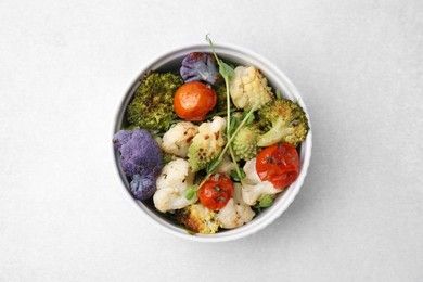 Photo of Delicious salad with cauliflower and tomato on white table, top view