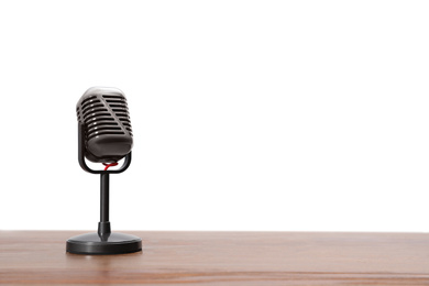 Photo of Vintage microphone on wooden table, space for text. Journalist's equipment