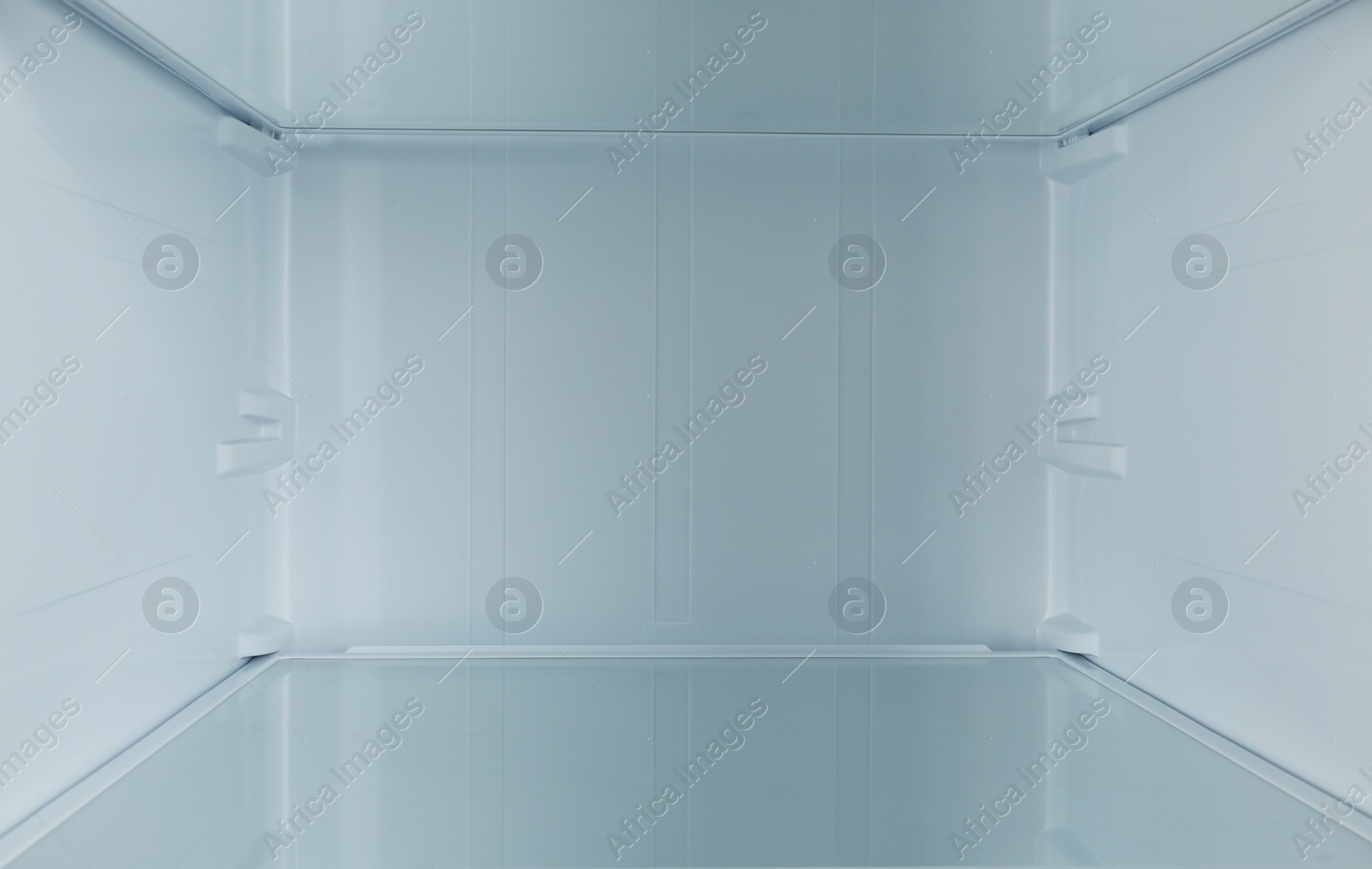 Photo of Shelf of empty modern refrigerator, closeup view