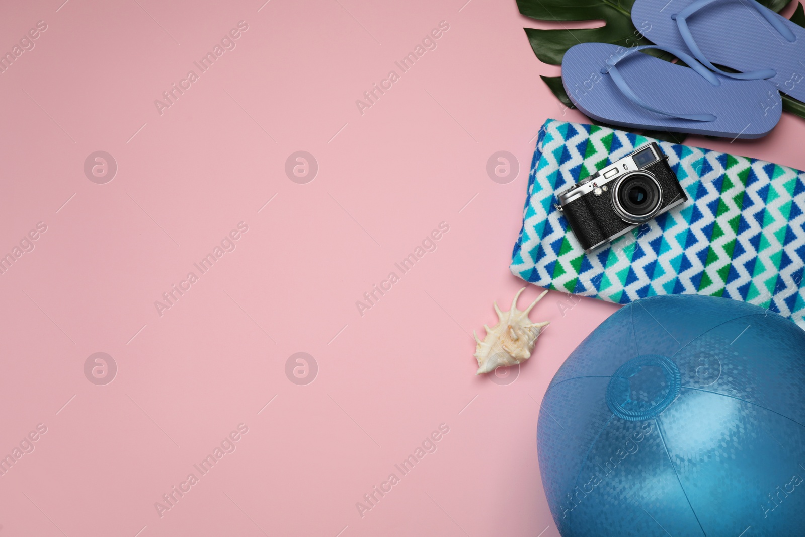 Photo of Flat lay composition with beach ball on pink background. Space for text