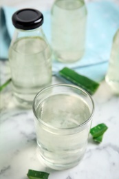 Photo of Fresh aloe drink on white marble table