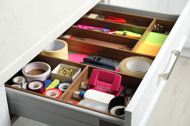 Different stationery in open desk drawer indoors