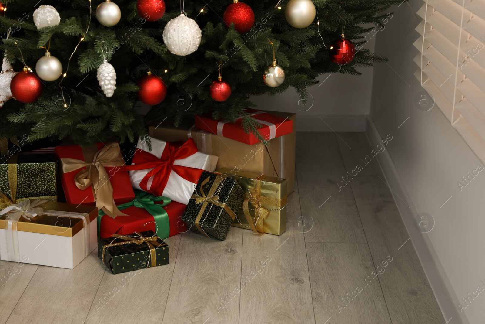 Photo of Beautifully decorated Christmas tree and gifts indoors