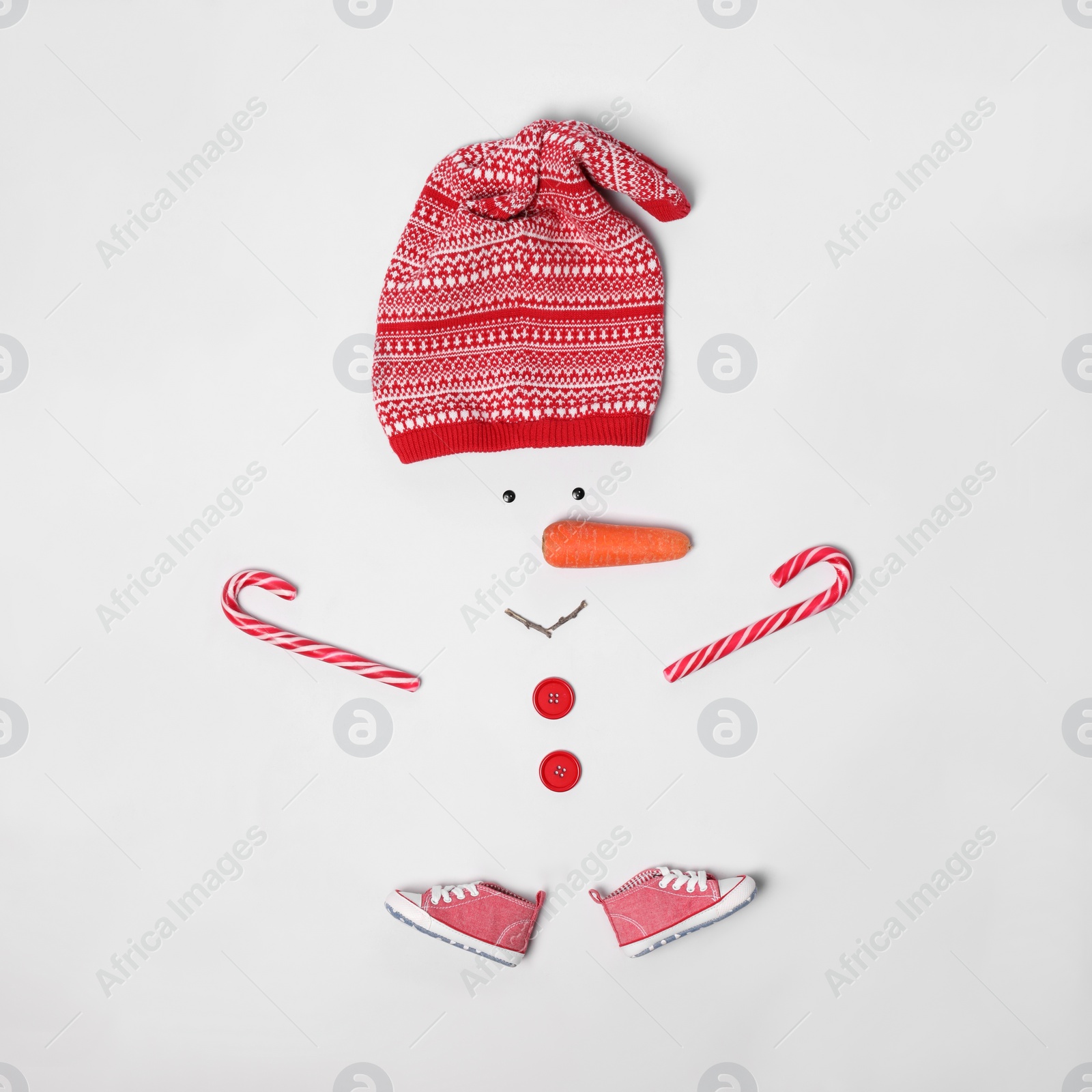 Photo of Creative snowman shape made of different items on white background, flat lay