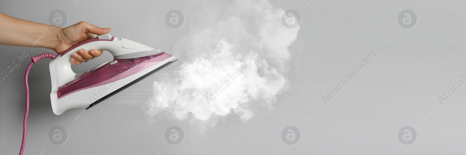 Image of Woman with iron on light grey background, closeup. Banner design with space for text