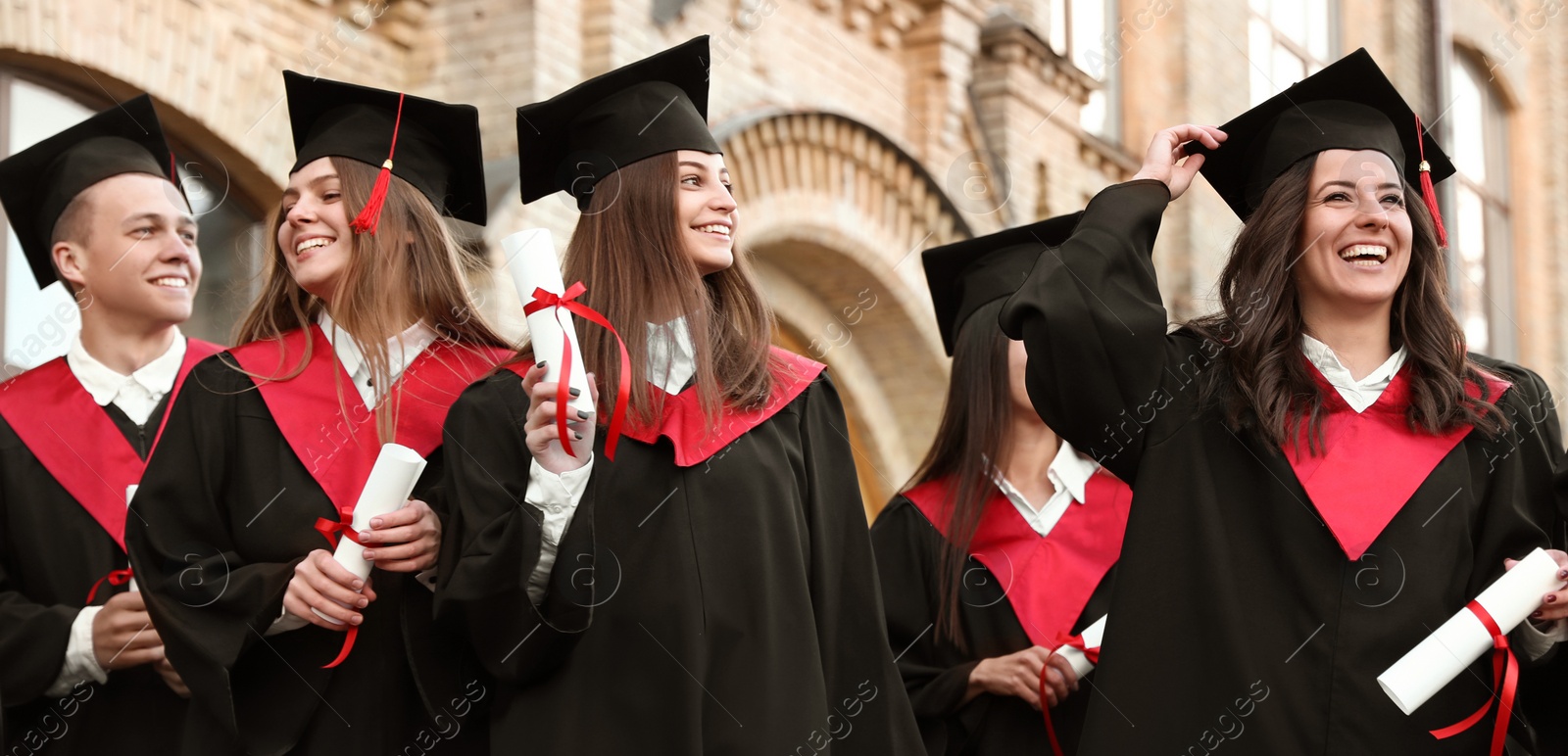 Image of Happy students with diplomas near campus. Banner design