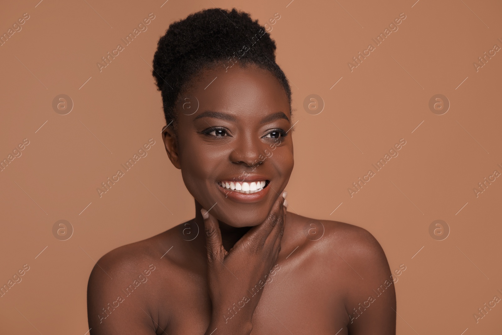 Photo of Portrait of beautiful happy woman on beige background