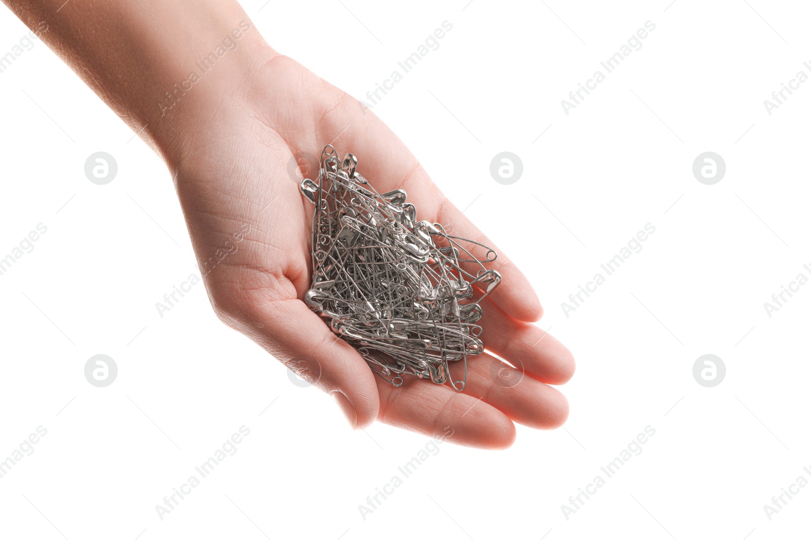 Photo of Woman holding pile of safety pins on white background, closeup